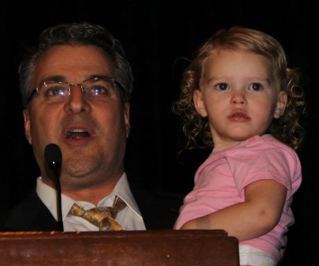 Desert Foot Conference manager Michael Shore, DPM holds the granddaughter of 